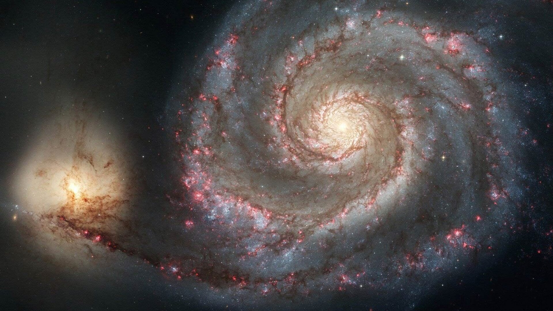 Why are some galaxies spiral shaped?